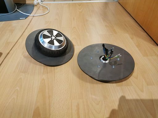 Two hoverboard wheels with steel disks mounted behind them