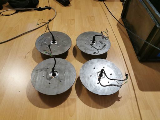 Four hoverboard wheels with steel disks mounted behind them