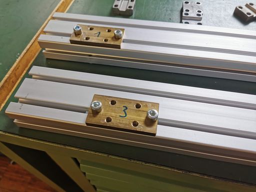 Two of the motor mounting plates mounted to two aluminium extrusions