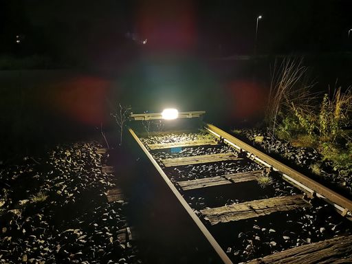 The kart on a track at night, with a bright light in front illuminating the track